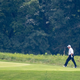 A lumpy fraud plays a round of golf.